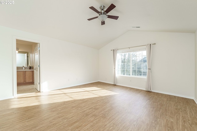 empty room featuring vaulted ceiling, ceiling fan, and light hardwood / wood-style flooring