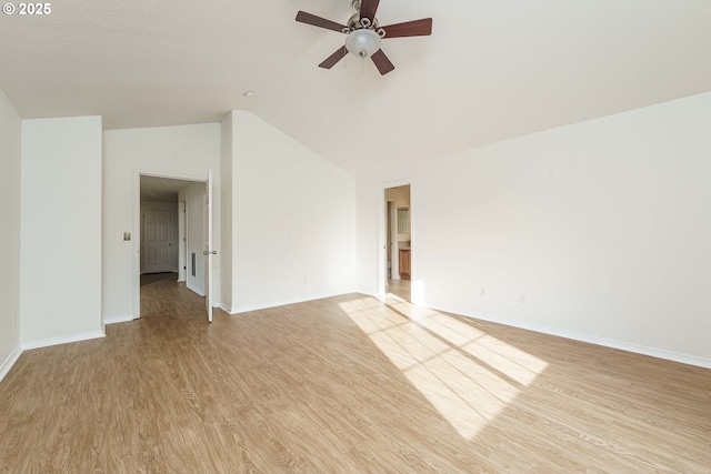 spare room featuring lofted ceiling, ceiling fan, and light wood-type flooring