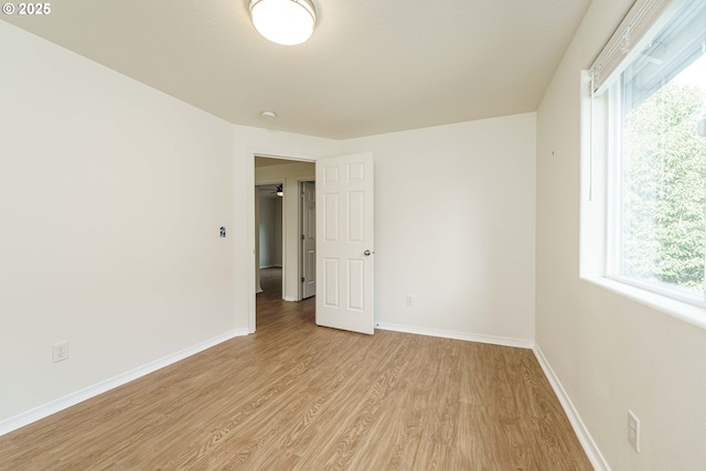 spare room featuring plenty of natural light and light wood-type flooring