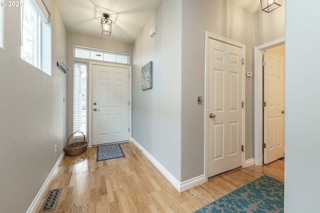 entrance foyer featuring a wealth of natural light and light hardwood / wood-style flooring