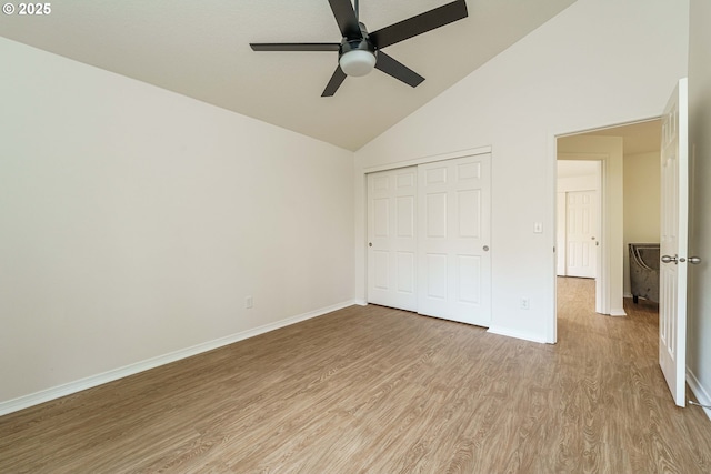 unfurnished bedroom with high vaulted ceiling, light hardwood / wood-style floors, a closet, and ceiling fan