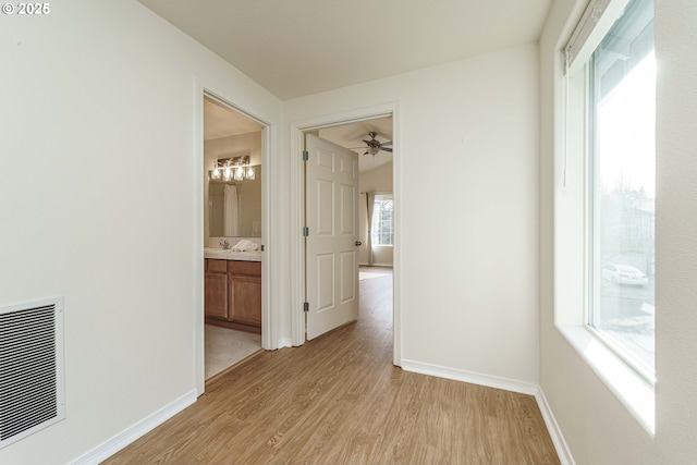 corridor with light hardwood / wood-style flooring