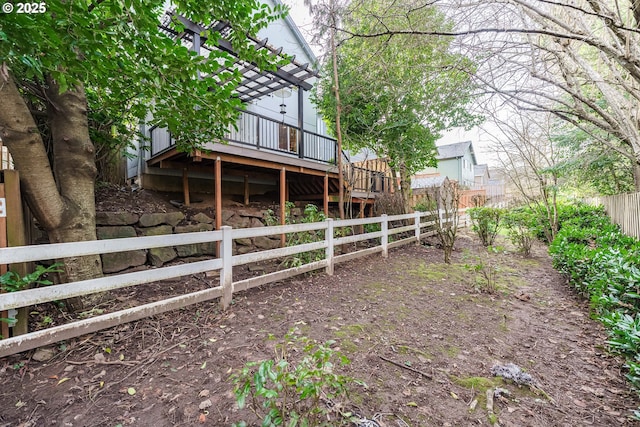 view of yard with a wooden deck and a pergola