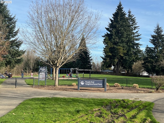 view of property's community with a playground and a yard