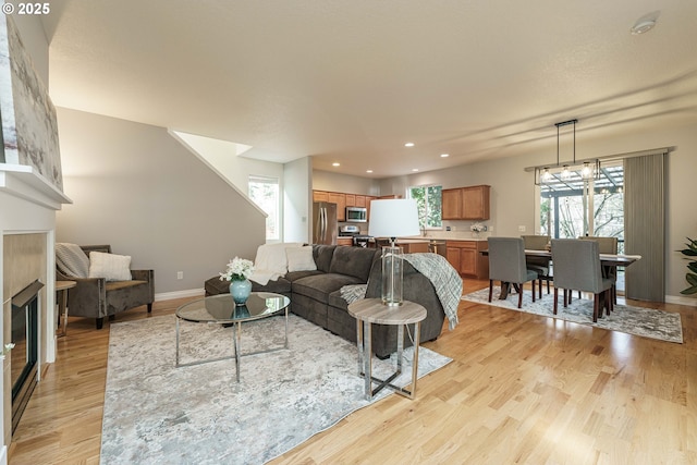 living room featuring an inviting chandelier and light wood-type flooring