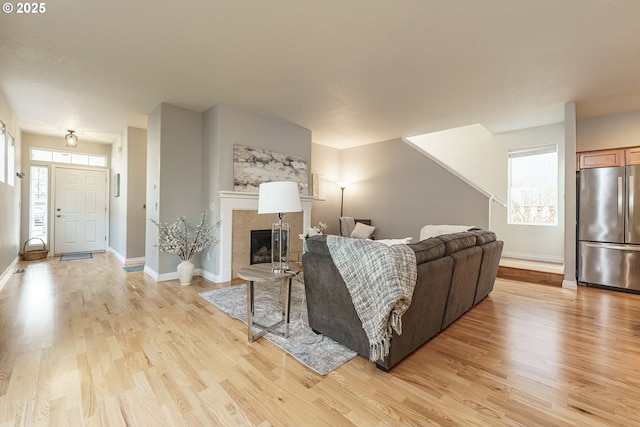 living room featuring a fireplace and light wood-type flooring