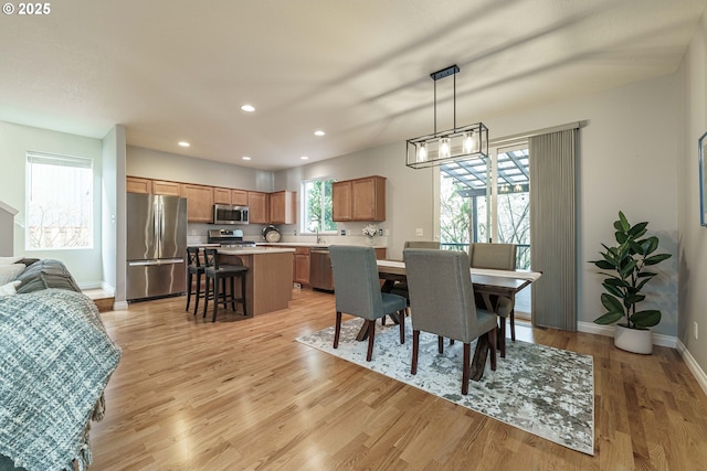 dining space featuring a wealth of natural light and light hardwood / wood-style floors