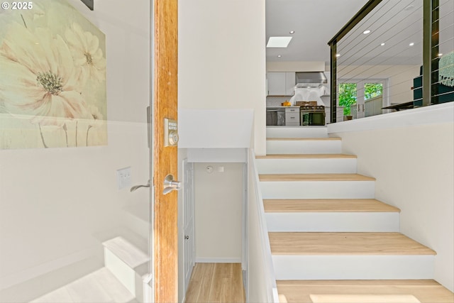 5017 SW Fairvale Ct, Portland, OR 97221 - staircase featuring wood finished floors and recessed lighting