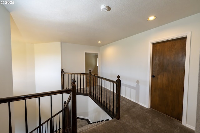 stairs with carpet floors, recessed lighting, baseboards, and a textured ceiling
