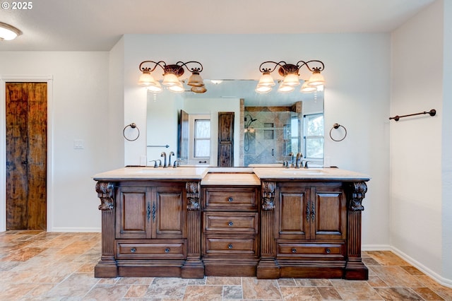 6765 SW 153rd Ave, Beaverton, OR 97007 - full bathroom featuring plenty of natural light, double vanity, a tile shower, and stone finish flooring