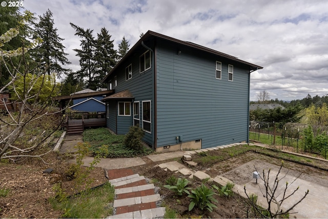 view of side of property with a wooden deck