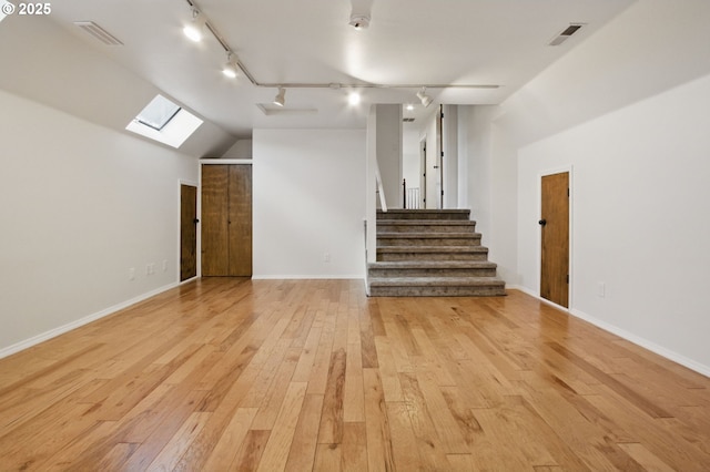 6765 SW 153rd Ave, Beaverton, OR 97007 - bonus room with a skylight, light wood-style floors, stairs, baseboards, and lofted ceiling
