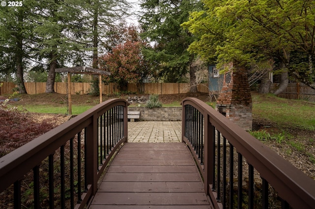 wooden deck featuring a fenced backyard