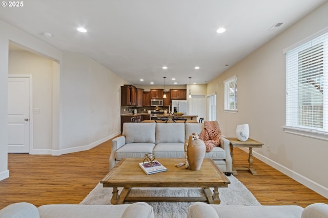 living room with light hardwood / wood-style floors