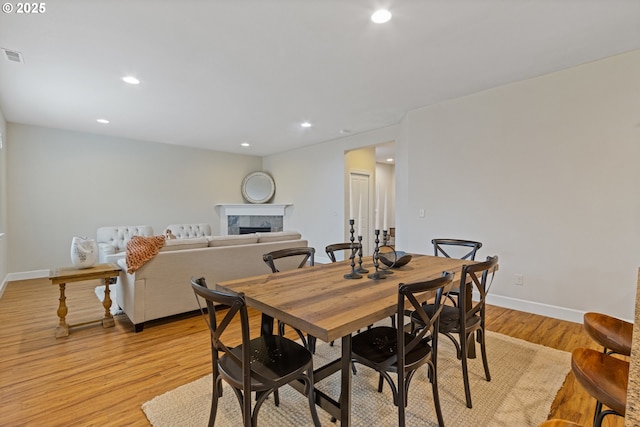 dining space with light hardwood / wood-style floors