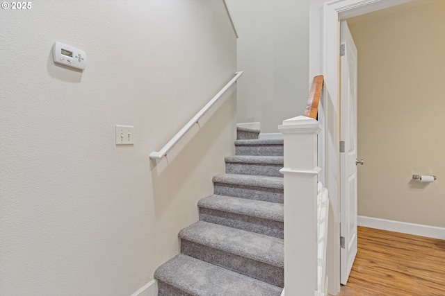 stairway featuring hardwood / wood-style flooring