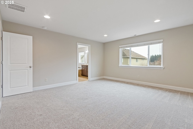 unfurnished room with light carpet