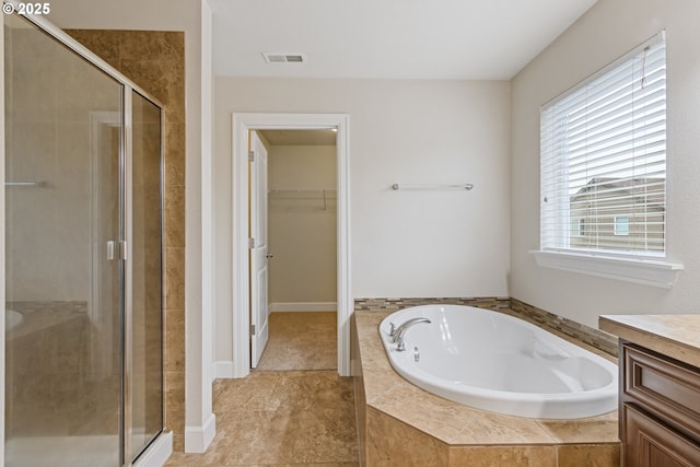 bathroom featuring plus walk in shower and vanity