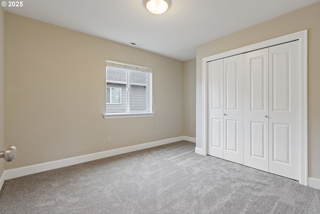 unfurnished bedroom with carpet floors and a closet