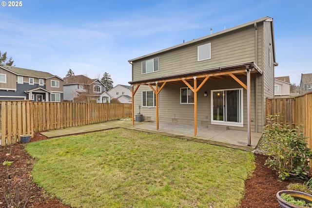 back of property with a patio area and a yard