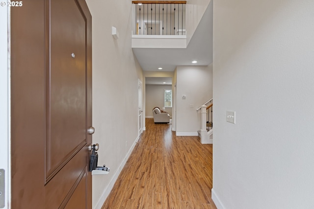 entrance foyer featuring light hardwood / wood-style floors and a high ceiling