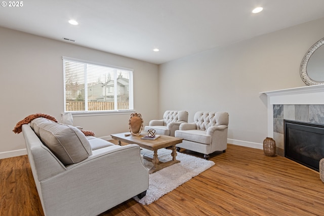 living room with hardwood / wood-style flooring and a fireplace