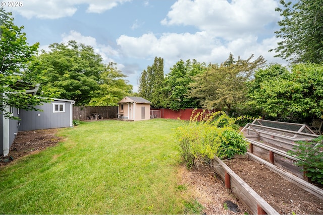 2115 NE 86th Ave, Vancouver, WA 98664 - view of yard featuring a storage unit, a garden, an outdoor structure, and view of scattered trees