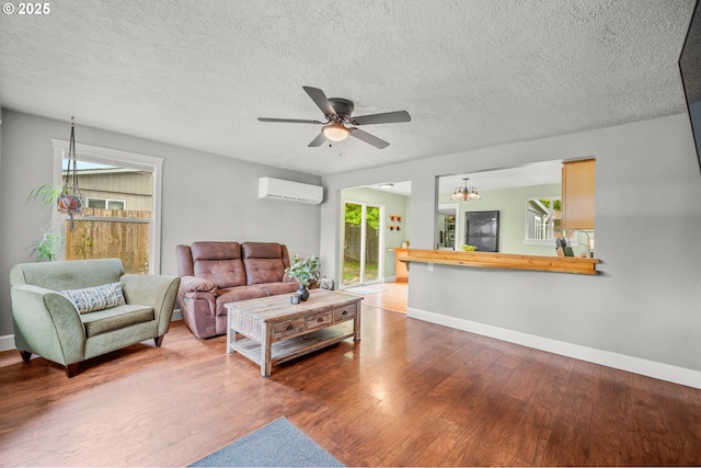 2115 NE 86th Ave, Vancouver, WA 98664 - living area with an AC wall unit, wood finished floors, baseboards, and a textured ceiling