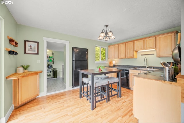 2115 NE 86th Ave, Vancouver, WA 98664 - kitchen featuring black appliances, a sink, light brown cabinets, light wood-style flooring, and a chandelier