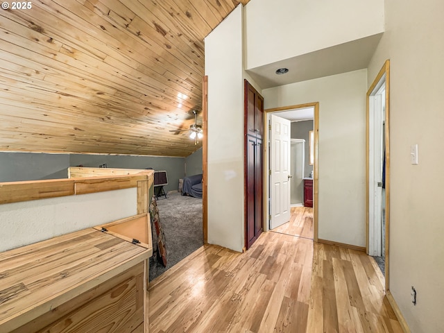 bonus room featuring vaulted ceiling, light wood finished floors, ceiling fan, wooden ceiling, and baseboards