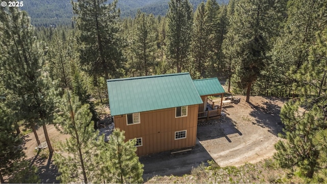 aerial view of property and surrounding area featuring a forest