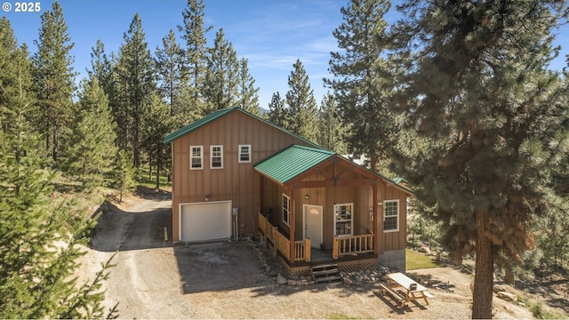 view of front of home featuring dirt driveway and board and batten siding