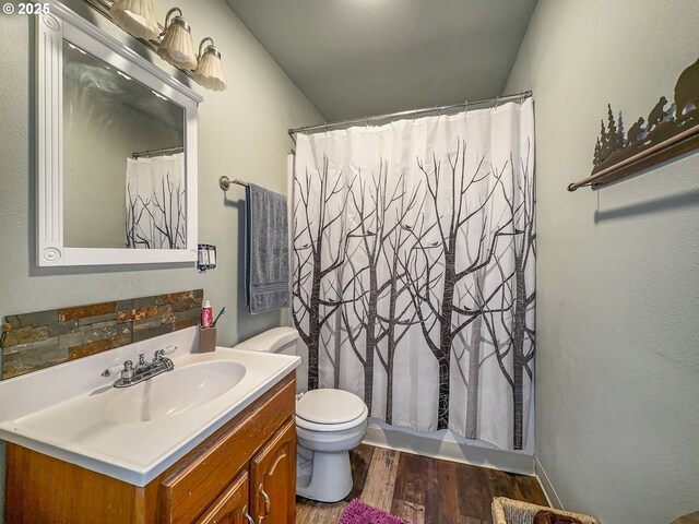 bathroom featuring wood finished floors, vanity, toilet, and shower / bath combination with curtain