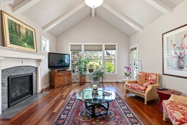living room with a fireplace, beam ceiling, and wood finished floors