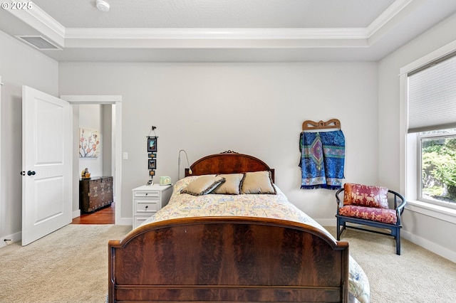 bedroom featuring crown molding, visible vents, baseboards, light colored carpet, and a raised ceiling