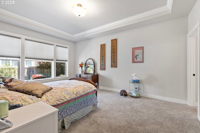 bedroom featuring carpet floors, crown molding, and a raised ceiling