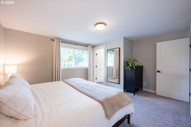 bedroom with light carpet and baseboards