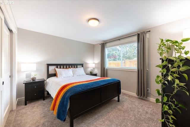 bedroom with carpet and baseboards