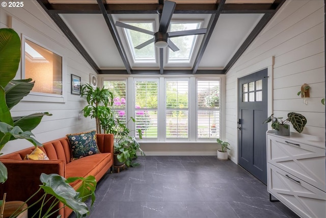 sunroom / solarium with wooden walls, healthy amount of natural light, a skylight, and french doors