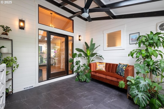 entrance to property featuring ceiling fan and a patio