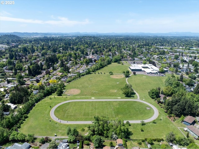 aerial view of property and surrounding area with nearby suburban area