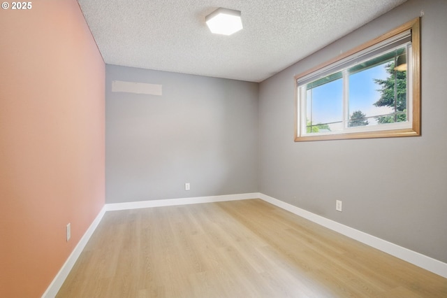 8616 NE 57th St, Vancouver, WA 98662 - unfurnished room featuring a textured ceiling, light wood-style flooring, and baseboards