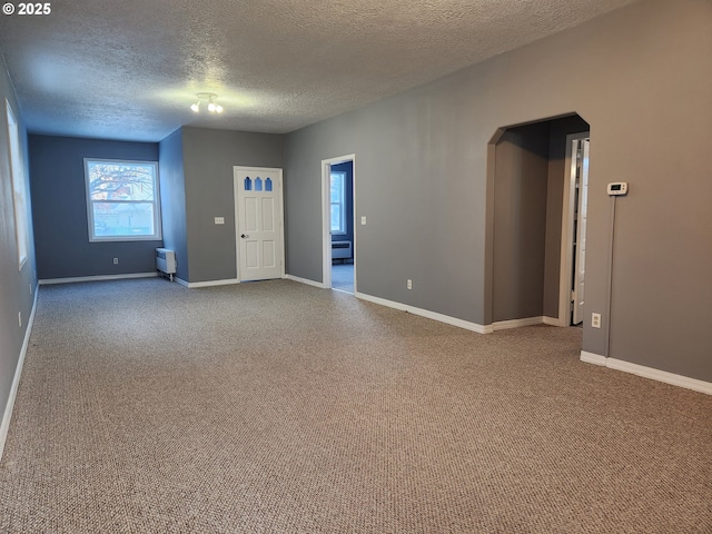 unfurnished room featuring carpet floors and a textured ceiling