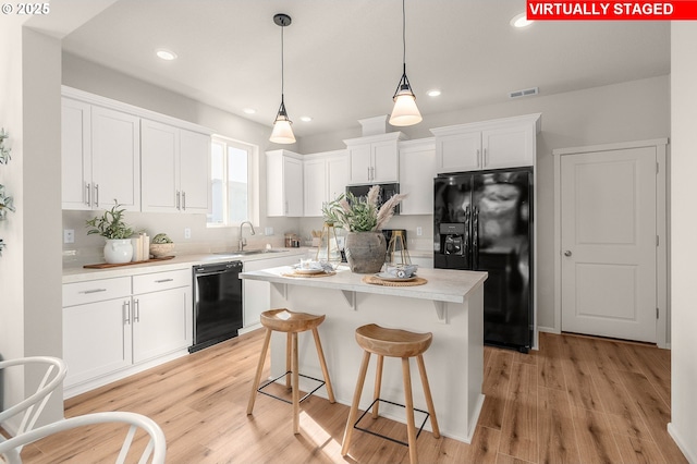 11325 NW Main St, North Plains, OR 97133 - kitchen with black appliances, a sink, white cabinets, light countertops, and recessed lighting
