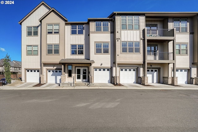 16417 NW Chadwick Way Unit 302, Portland, OR 97229 - view of front of home featuring a garage, board and batten siding, and stone siding