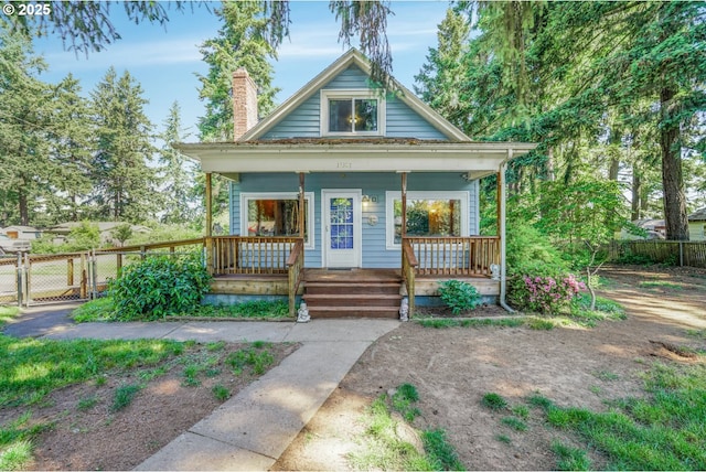13307 SE Raymond St, Portland, OR 97236 - bungalow-style house featuring a chimney, a porch, and a gate