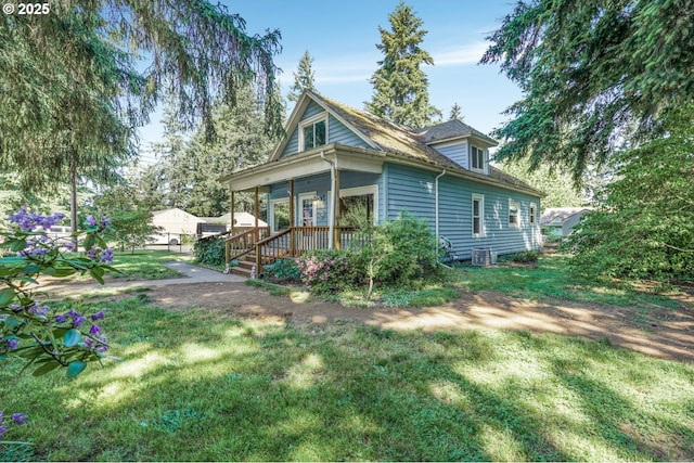 13307 SE Raymond St, Portland, OR 97236 - view of home's exterior featuring a yard, a porch, and central AC