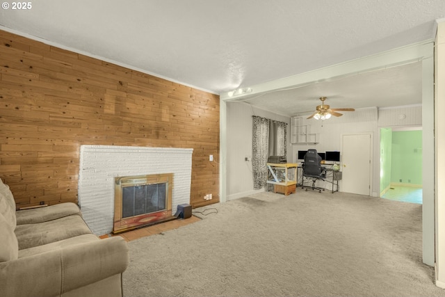 13307 SE Raymond St, Portland, OR 97236 - living area with an office area, wooden walls, ceiling fan, carpet floors, and a brick fireplace