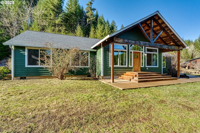 back of house with a yard and a patio