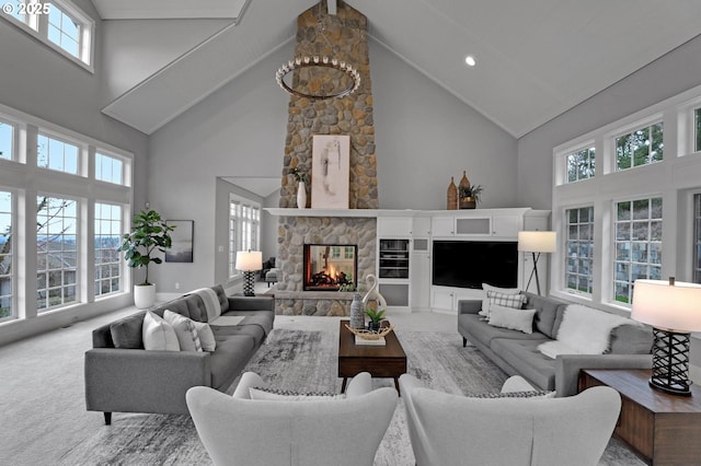 living area featuring a high ceiling, a stone fireplace, and carpet flooring